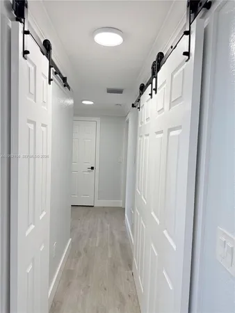 a view of a hallway with a white walls