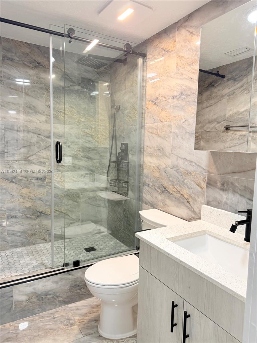 7330 Northwest 174th Terrace, Unit 204 Hialeah, FL 33015 - Photo 9 of 18 a bathroom with a shower a toilet and a sink