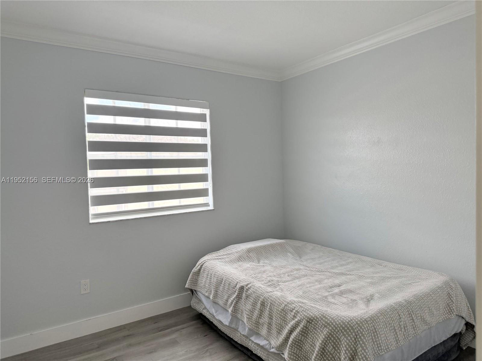 7330 Northwest 174th Terrace, Unit 204 Hialeah, FL 33015 - Photo 10 of 18 a bedroom with a bed and a window