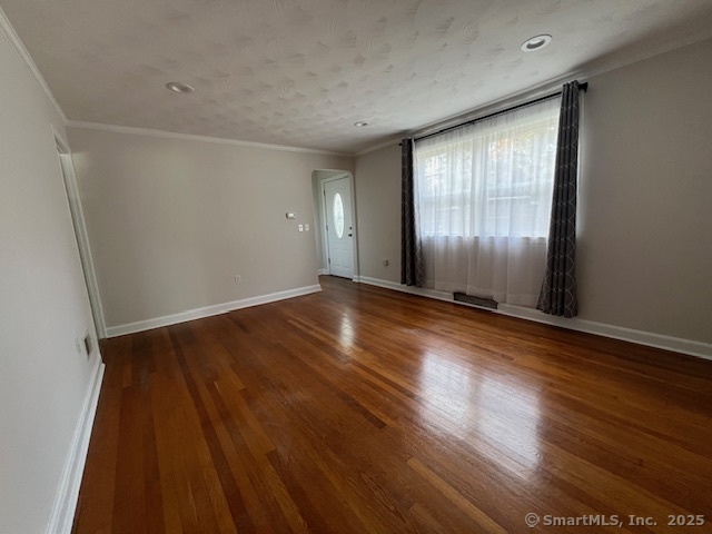 451 Meadow Street Fairfield, CT 06824 - Photo 2 of 9 a view of an empty room with wooden floor and a window