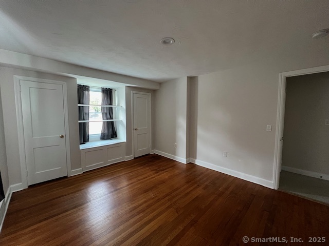 451 Meadow Street Fairfield, CT 06824 - Photo 6 of 9 an empty room with wooden floor and windows