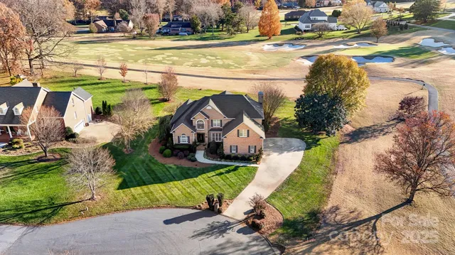a view of a house with a yard and plants