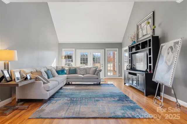 a living room with furniture a rug and a flat screen tv