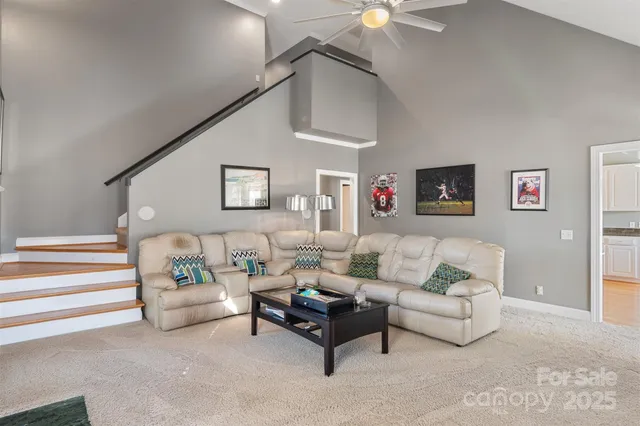 a living room with furniture and a ceiling fan