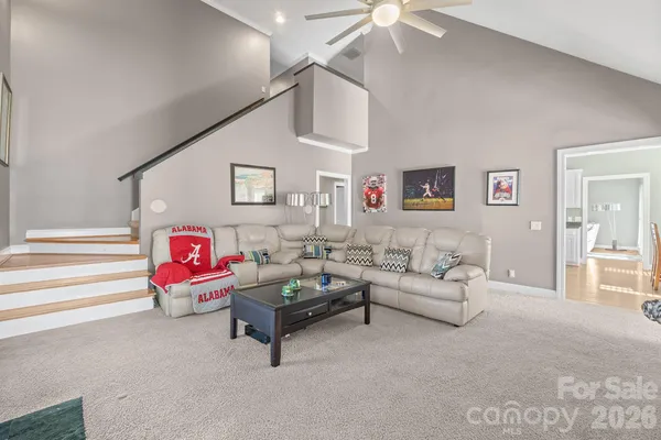 a living room with furniture and a ceiling fan