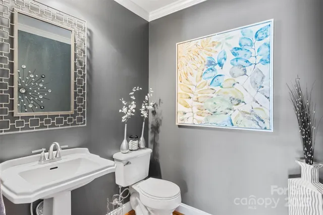 a bathroom with a sink mirror and toilet