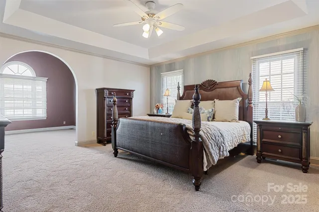 a bedroom with a bed and a chandelier
