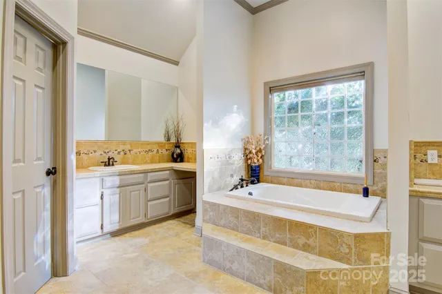 a spacious bathroom with sink shower bathtub and next to a window