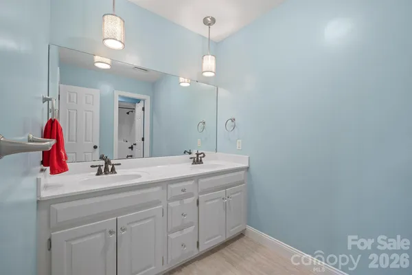 a bathroom with a sink vanity and a mirror