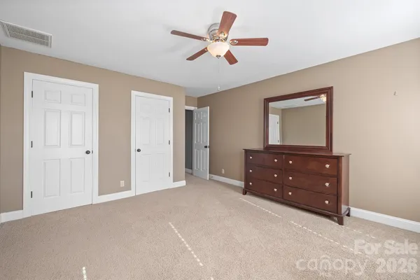 a room that has a dresser and a mirror on dresser