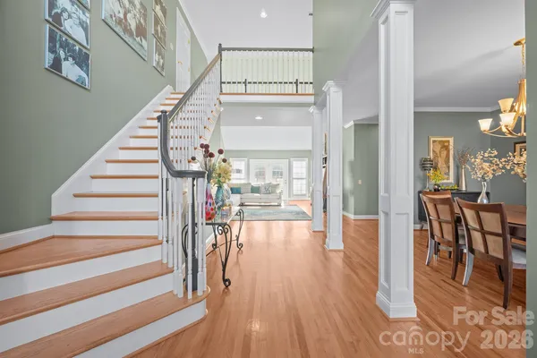 a view of entryway and hall with wooden floor
