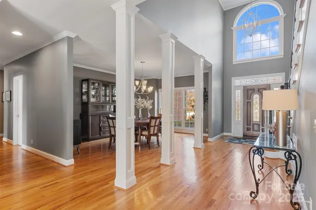 a view of a room with wooden floor and windows