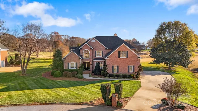 a front view of house with yard and green space