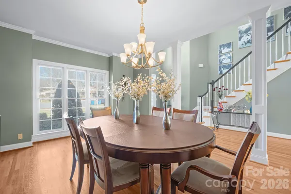 a view of a dining room with furniture and a chandelier