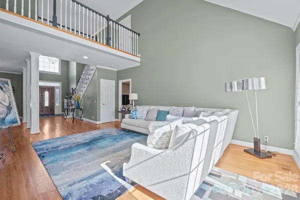 a living room with furniture and a wooden floor