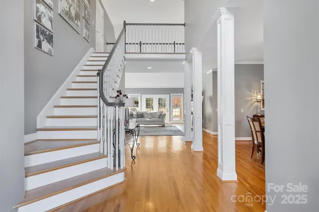 a view of entryway and hall with wooden floor