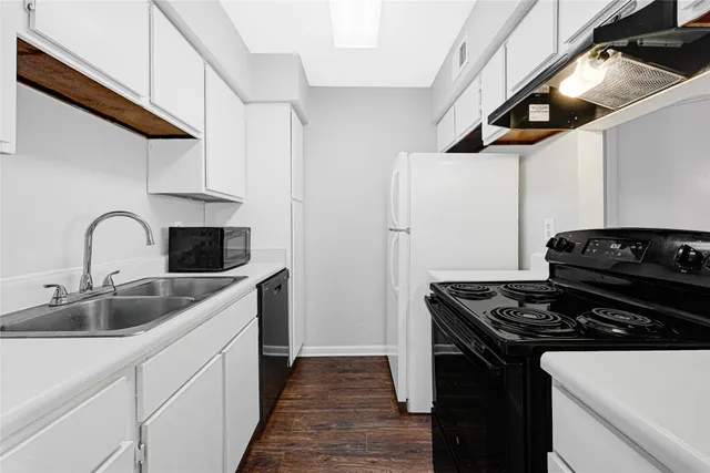 a kitchen with stainless steel appliances a sink and a stove