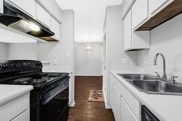 a kitchen with stainless steel appliances granite countertop a sink and a stove