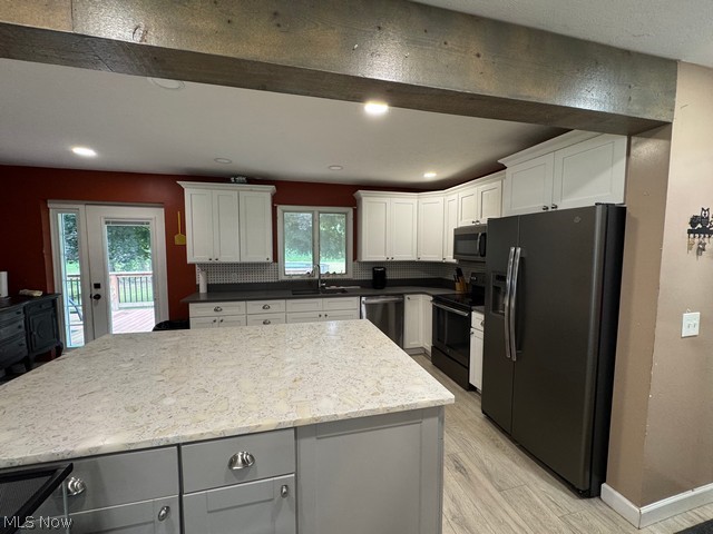 620 Ravenna Road Newton Falls, OH 44444 - Photo 4 of 23 Kitchen featuring a large central island with a light-colored countertop, white upper and lower cabinetry, a dark gray countertop, recessed lighting, and wood-finish flooring