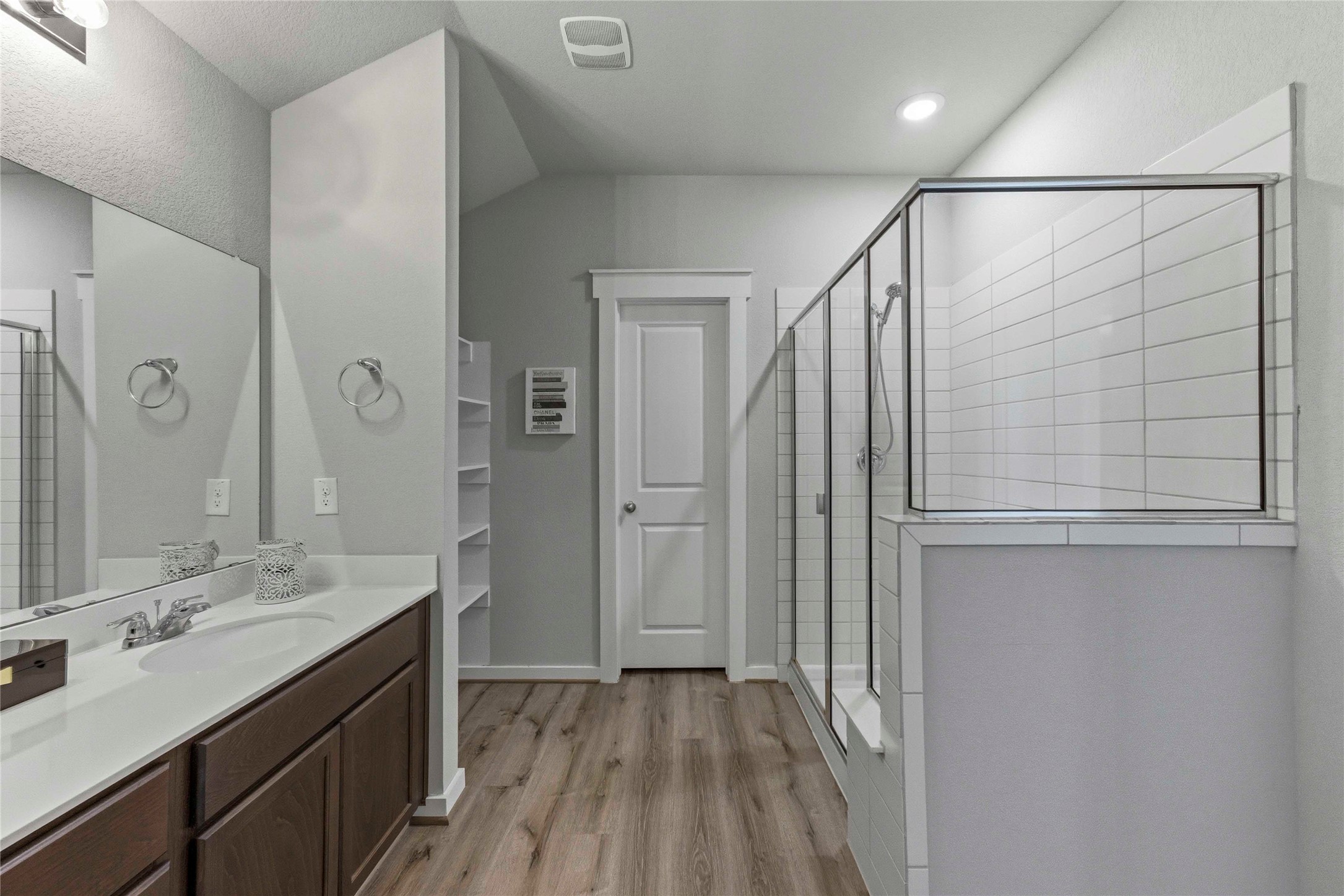 17203 Leafroller Drive, Unit B Pflugerville, TX 78660 - Photo 14 of 20 a bathroom with a double vanity sink and mirror