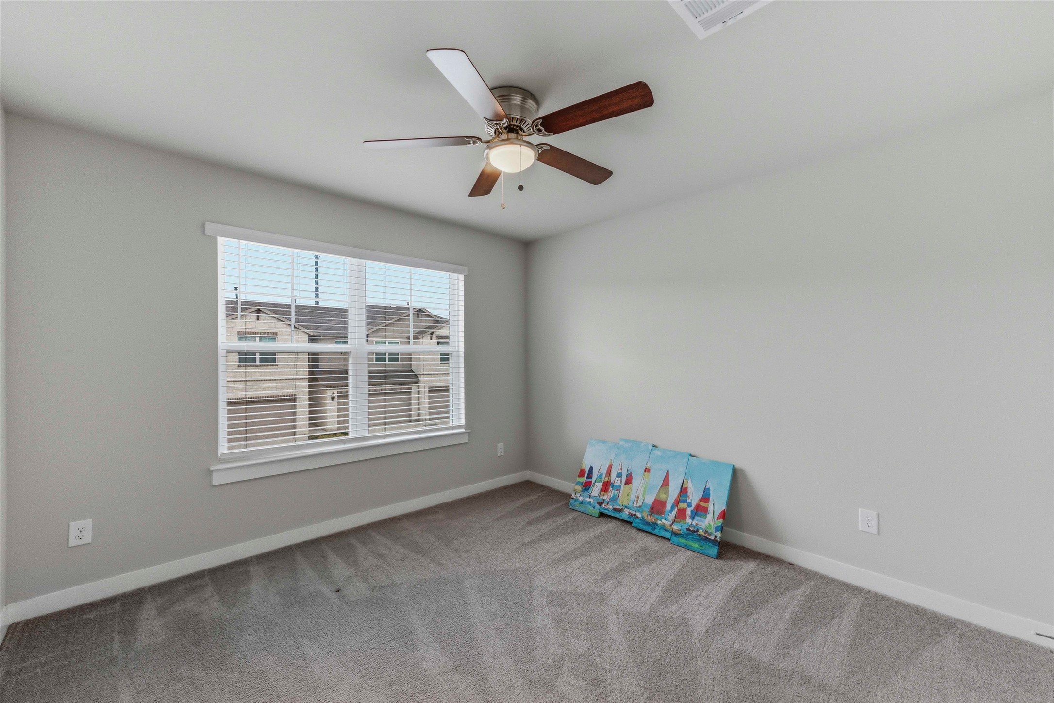 17203 Leafroller Drive, Unit B Pflugerville, TX 78660 - Photo 16 of 20 an empty room with ceiling fan and windows