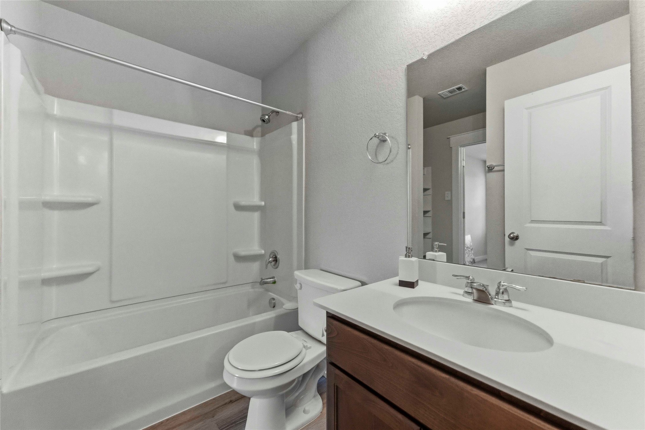 17203 Leafroller Drive, Unit B Pflugerville, TX 78660 - Photo 17 of 20 a bathroom with a sink a toilet and shower