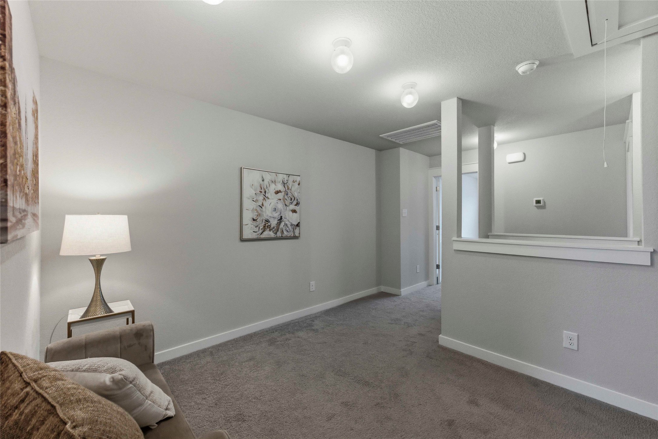 17203 Leafroller Drive, Unit B Pflugerville, TX 78660 - Photo 9 of 20 a living room with furniture and a lamp