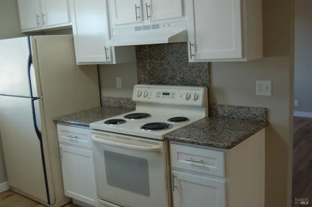 a kitchen with a stove and a refrigerator
