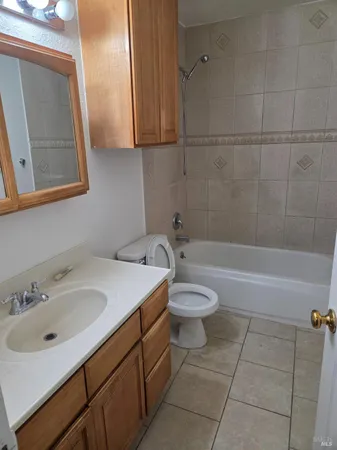 a bathroom with a sink a toilet and bathtub