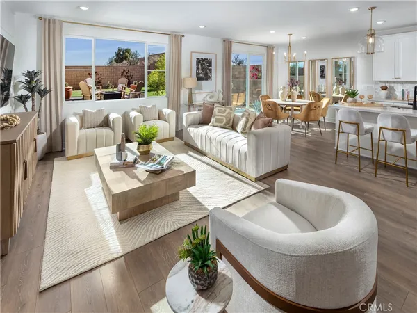 a living room with furniture kitchen view and a large window