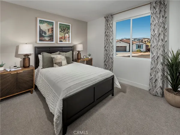 a bedroom with a bed and a night stand