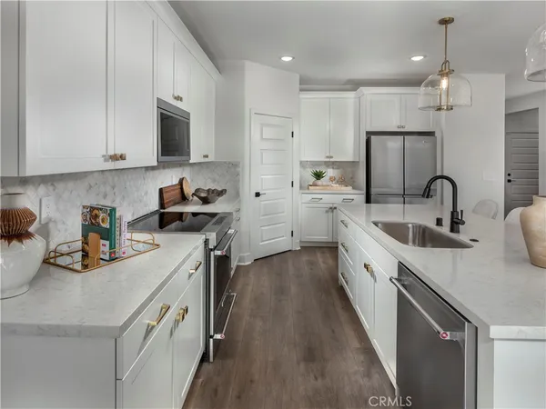 a kitchen with cabinets a sink and appliances