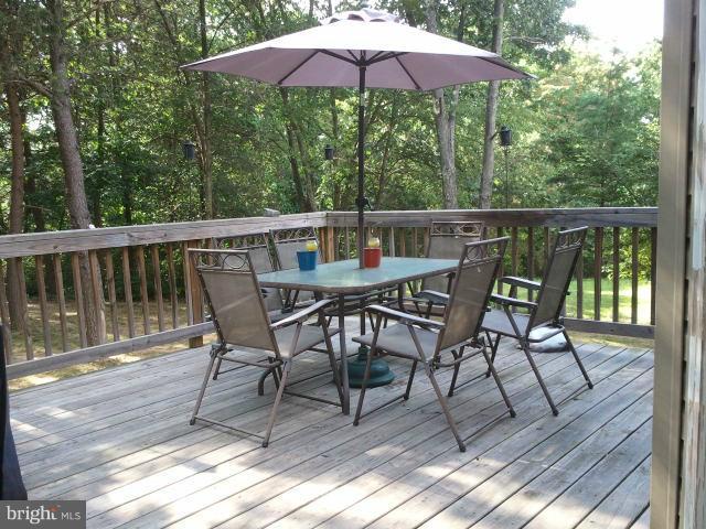 168 Holiday Road Cross Junction, VA 22625 - Photo 1 of 29 a view of balcony with wooden floor and outdoor seating