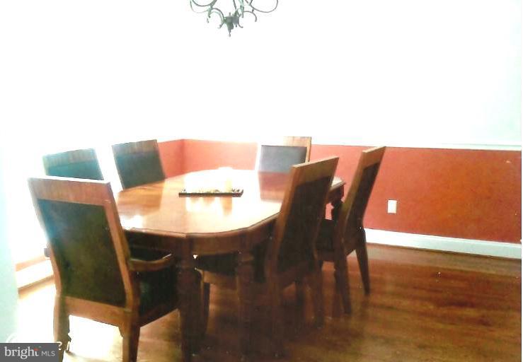 168 Holiday Road Cross Junction, VA 22625 - Photo 11 of 29 a view of a dining room with furniture and wooden floor