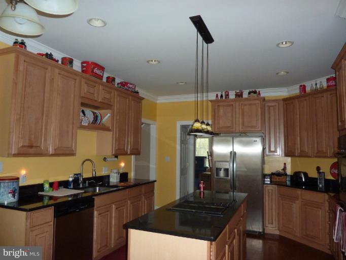 168 Holiday Road Cross Junction, VA 22625 - Photo 18 of 29 a kitchen with granite countertop a sink a stove and refrigerator