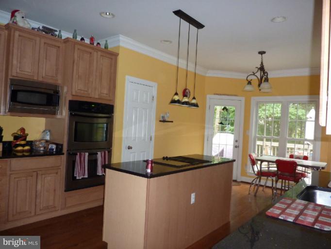 168 Holiday Road Cross Junction, VA 22625 - Photo 21 of 29 a kitchen with stainless steel appliances granite countertop a stove and a refrigerator