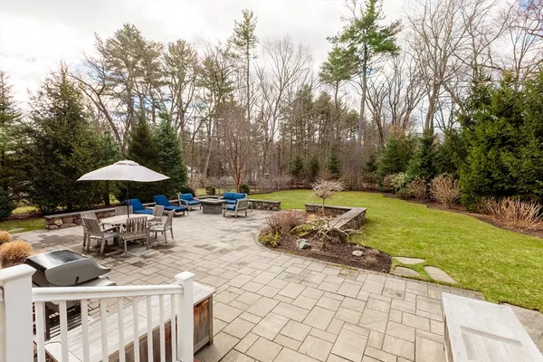 a view of a patio with a table and chairs under an umbrella