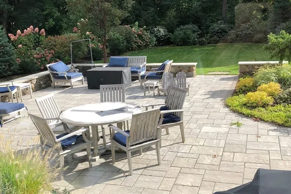 a view of a patio with table and chairs potted plants with lake view