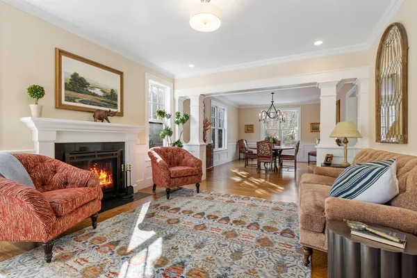 a living room with furniture a large window and a fireplace