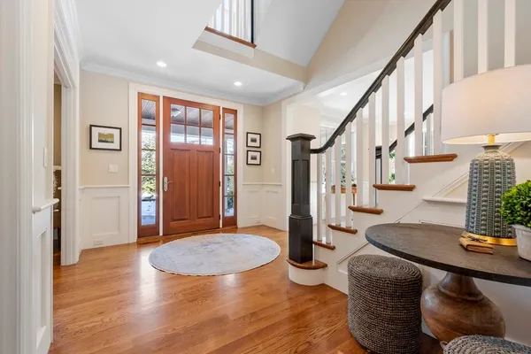a view of entryway and hall with wooden floor
