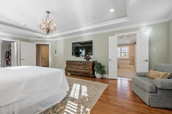 a spacious bedroom with a bed and a couch