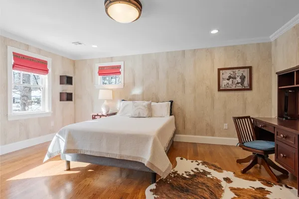 a bedroom with a bed and a chair