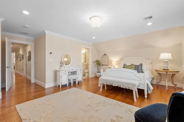 a bedroom with furniture and a wooden floor