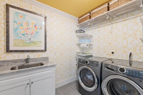 a bathroom with a sink a washer and dryer