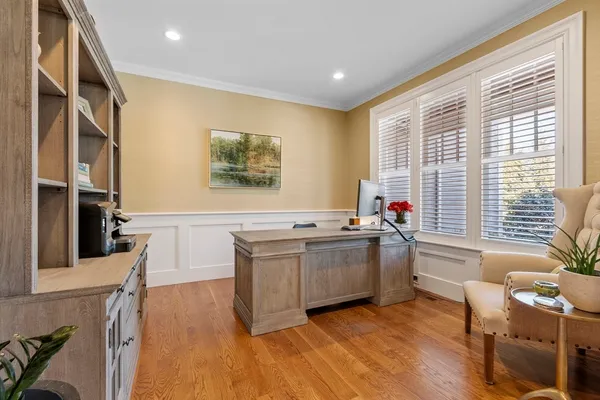 a kitchen with a sink cabinets and wooden floor