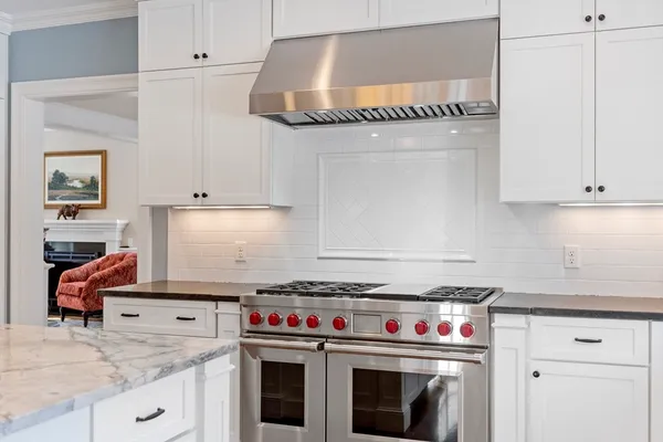 a kitchen with granite countertop a stove and a sink
