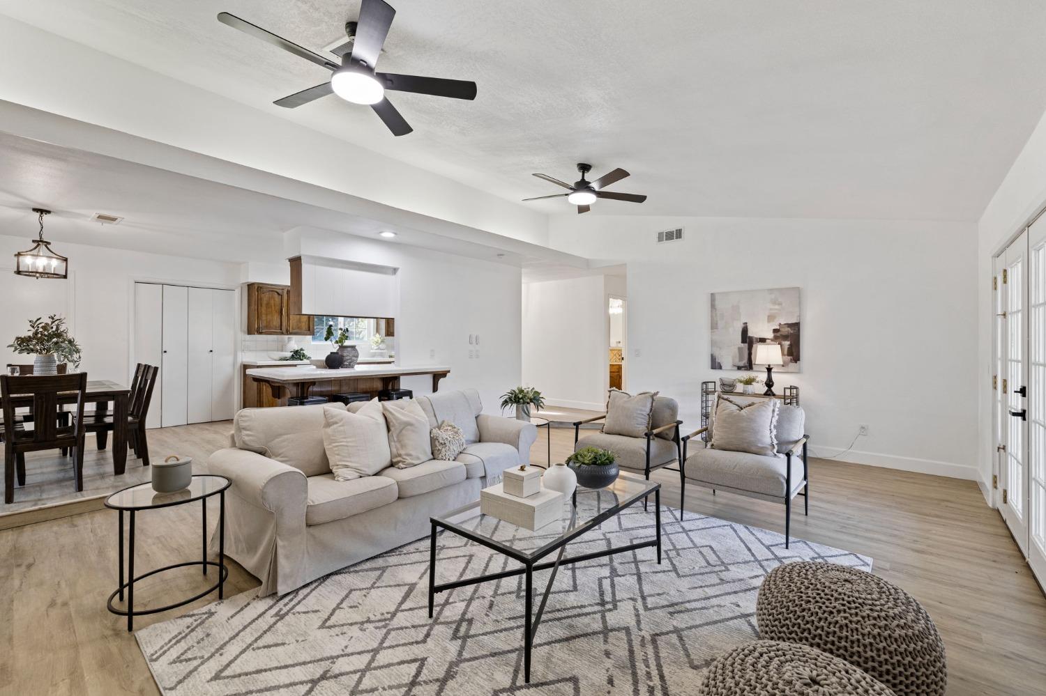 17153 Rodeo Drive Madera, CA 93638 - Photo 7 of 22 a living room with furniture or kitchen view and a chandelier