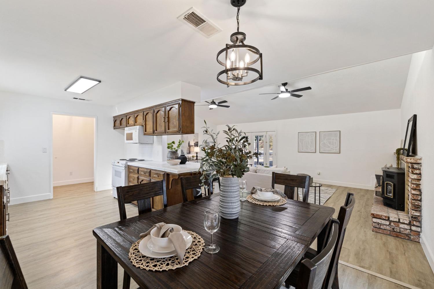 17153 Rodeo Drive Madera, CA 93638 - Photo 9 of 22 a view of a dining room with furniture a chandelier and wooden floor