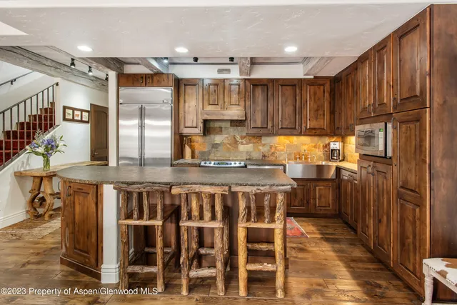 a kitchen with kitchen island granite countertop wooden cabinets and counter space