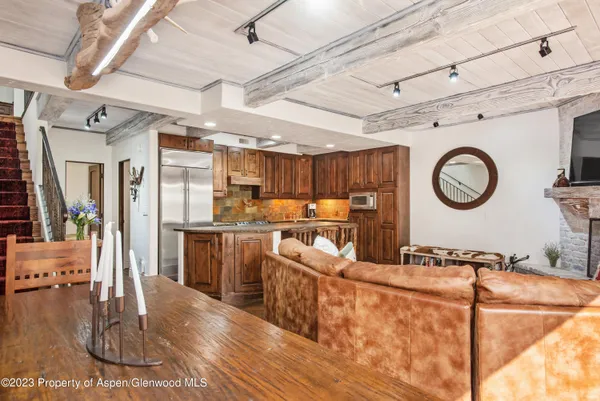 a living room with stainless steel appliances granite countertop furniture and a kitchen view